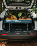 two people laying on a double 40 sleeping platform with a mattress