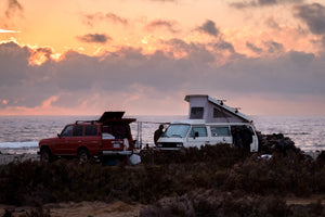 closer shot of two vehicles on a baja surf trip