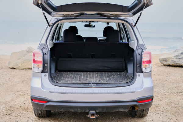subaru forester trunk open with hideaway sleeping platform packed and stored